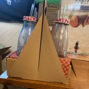 pink table cloths, pink cutlery, gingham mil bottles with lids and straws